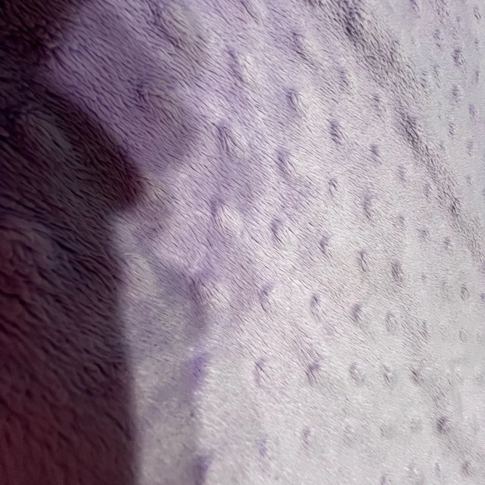 Source Unknown - Purple changing pad cover and White polka dot blanket.